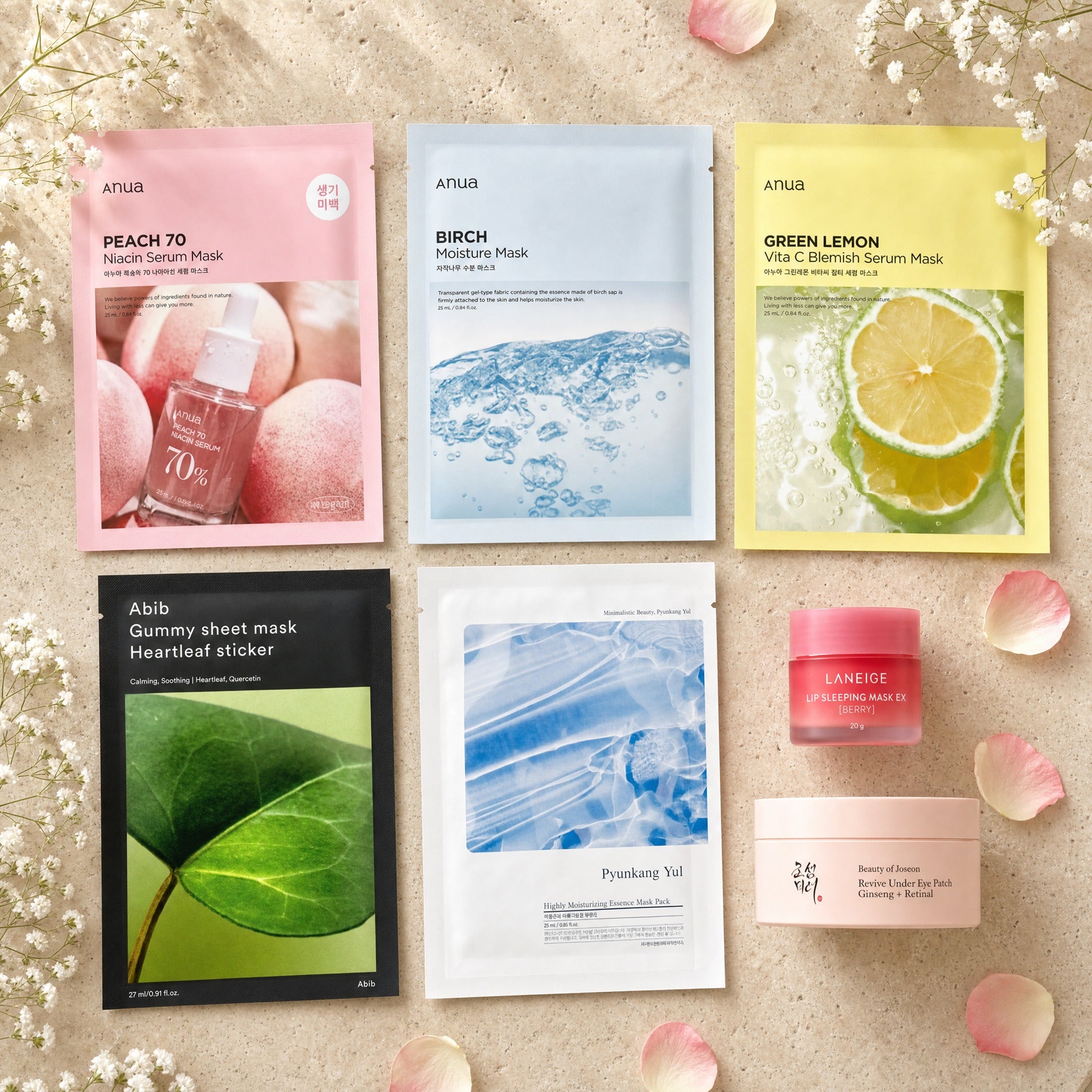 The Mini Ritual gift set — Anua Peach/Birch/Green-Lemon masks, Abib Gummy, Pyunkang Yul, Laneige lip mask and BoJ Revive eye-patch jar on travertine