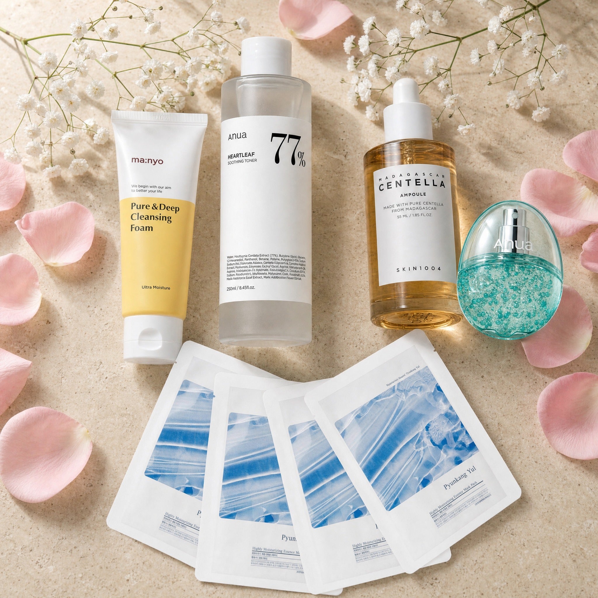 The Pregnancy Calm Set — Ma:nyo cleansing foam, Anua Heartleaf 77% toner, SKIN1004 Centella ampoule, Anua PDRN hydrating mist and four Pyunkang Yul essence masks on travertine