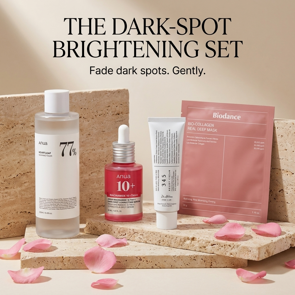 The Dark-Spot Brightening Set — static ad with all four products styled on travertine stone with rose petals