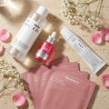 The Dark-Spot Brightening Set — Anua Heartleaf toner, Anua TXA serum and Dr. Althea 345 Relief Cream, including four Biodance collagen sheet masks