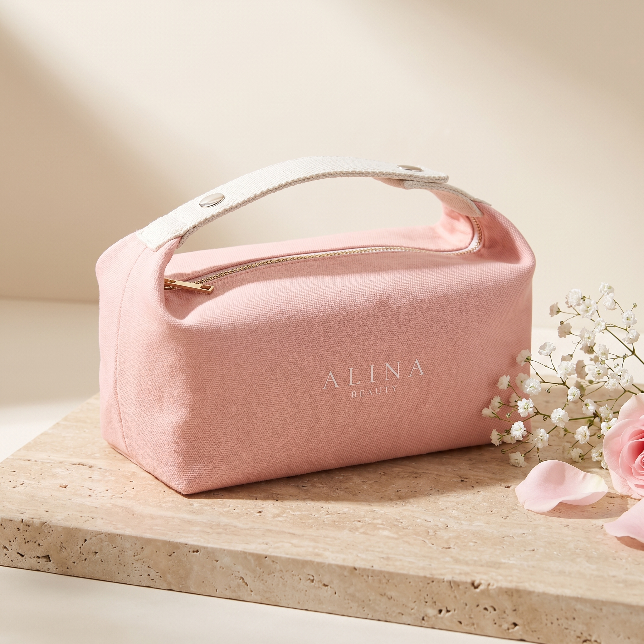 The Alina Beauty Bag in blush pink 100% cotton canvas with cream webbing handle and gold zip